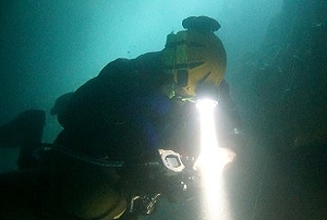 A British cave diver checks his gauges